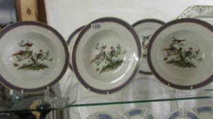 A set of six Grimwades bird decorated soup bowls and two plates.