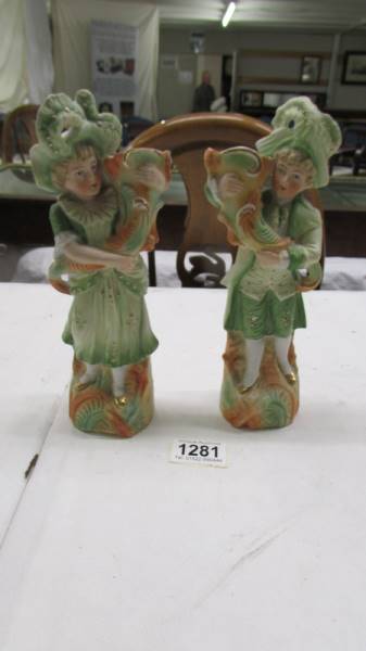 A pair of continental porcelain figural spill vases. 23 cm.