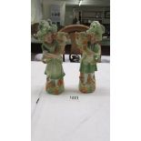 A pair of continental porcelain figural spill vases. 23 cm.