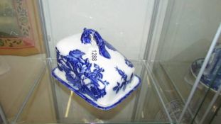 A blue and white Ironstone cheese dish.