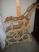 A pair of Victorian Colebrookdale cast iron bench ends depicting a serpent and dog.