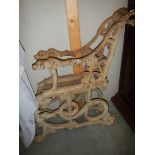 A pair of Victorian Colebrookdale cast iron bench ends depicting a serpent and dog.