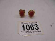 A pair of yellow gold earrings set coral (test as 18ct), total weight 6.6 grams.