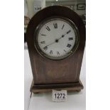 A mahogany inlaid mantel clock.