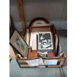 A quantity of frames containing old family photographs.