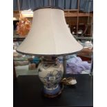 A blue and white oriental ginger jar with gilding detail table lamp.