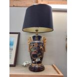 A hand painted classical style table lamp with shade.