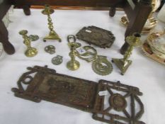 A mixed lot of horse brasses, candlesticks etc.,