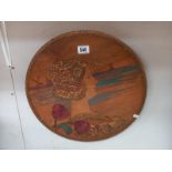 A vintage carved and painted, wooden wall plaque of a Dutch lady. Diameter 46cm.