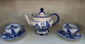 A blue & white Ironstone teapot & 2 matching cups & saucers