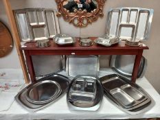 A quantity of stainless steel serving dishes.