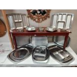 A quantity of stainless steel serving dishes.