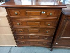 A mahogany veneered chest of drawers. 78cm x 38cm x height 92cm.