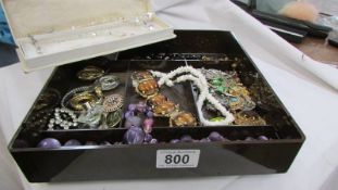 A mixed lot of costume jewellery including necklaces, brooches etc.,