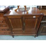 A modern solid wood TV cabinet. Opening doors over drop down front. Collect Only.
