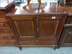 A modern solid wood TV cabinet. Opening doors over drop down front. Collect Only.