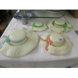 Four ceramic wall bonnets.