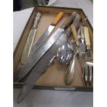 A selection of antique carving knives and other cutlery.