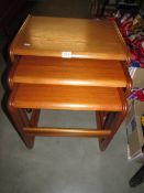 A good clean nest of three teak tables.