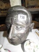 A plaster male head, chips to ear.