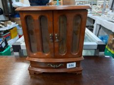 A jewellery box with contents including necklaces, Red Cross items etc.,