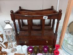 An oak mid 20th century magazine rack with single drawer.