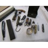 A tray of vintage pocket knives, cork screws, small brass spirit level etc.,