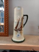 A tall Royal Doulton pitcher with sailing boat decoration. A/F. Height 38cm.