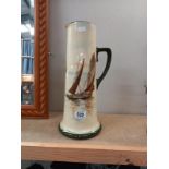 A tall Royal Doulton pitcher with sailing boat decoration. A/F. Height 38cm.