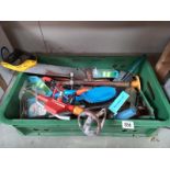 A box of various tools, including 4 new packs of fishing line.