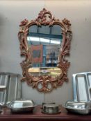 A gilt ormolu framed mirror 57cm x 91cm. Collect Only.