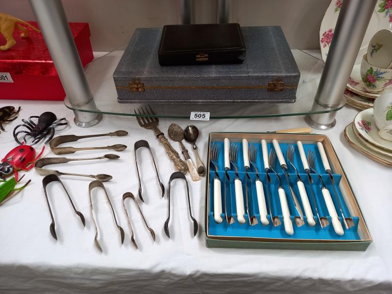 A quantity of silver plated flatware including sugar tongs.