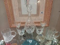 A cut glass decanter and selection of glasses. Collect Only.