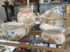 A Fielding Crown Devon spring teapot on stand and three pieces of Crown Ducal Louis china.