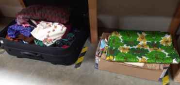 A suitcase and box of vintage linen including 1970's green floral pattern.