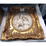 A gilded plaque with mother & child in the centre