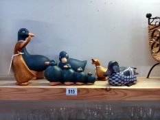A quantity of wooden duck ornaments.