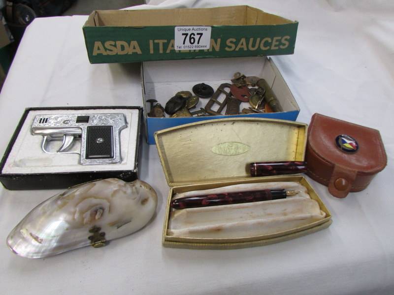 A mixed lot including pistol lighter, fountain pen, badges, buttons etc.,