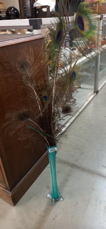 A 1930's blue glass spill vase containing peacock feathers (vase 40 cm).