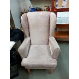 A light brown draylon wing armchair.