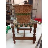 A vintage wicker waste paper bin and oak foot stool with woolwork top.