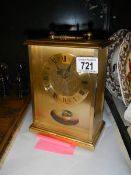 A brass mantel clock.