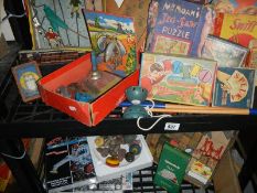 Two shelves of vintage games (unchecked for completeness).