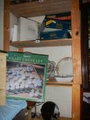 A shelf of games including glass chess set.