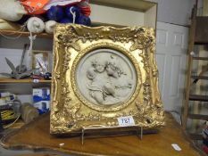 A gilt framed cherub plaque.