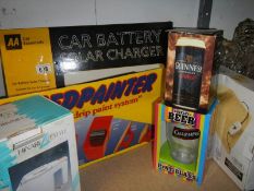 A boxed car battery solar charges and other boxed items.