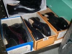 Four pairs of new men's black shoes, size 8.