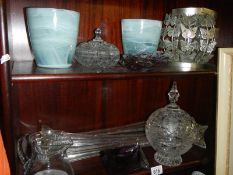 Three tall glass spill vases and other glass ware, two shelves.