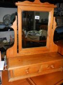 A pine toilet mirror with two drawers.