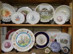 Two shelves of assorted collector's plates.